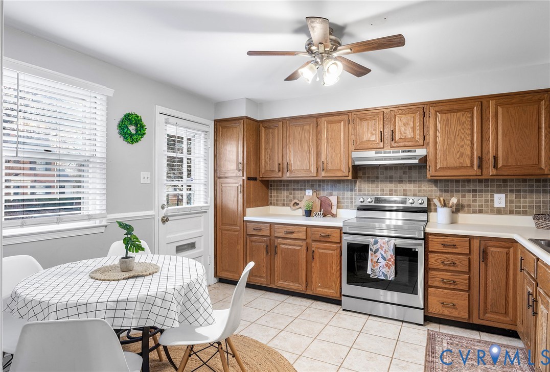 6020 Bonneau Road Richmond, VA 23227 - Photo 12 of 36 a kitchen with a sink cabinets and window