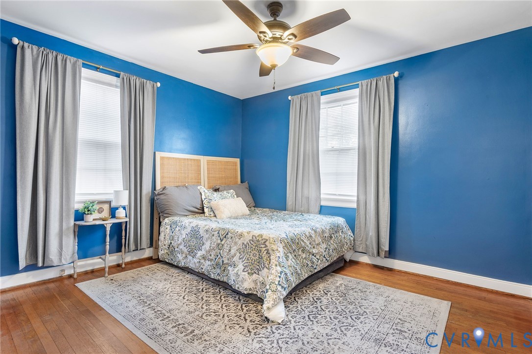 6020 Bonneau Road Richmond, VA 23227 - Photo 17 of 36 a bedroom with a large bed and a chandelier