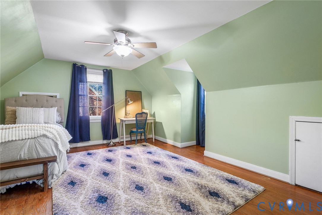 6020 Bonneau Road Richmond, VA 23227 - Photo 23 of 36 a bedroom with a bed and a chandelier
