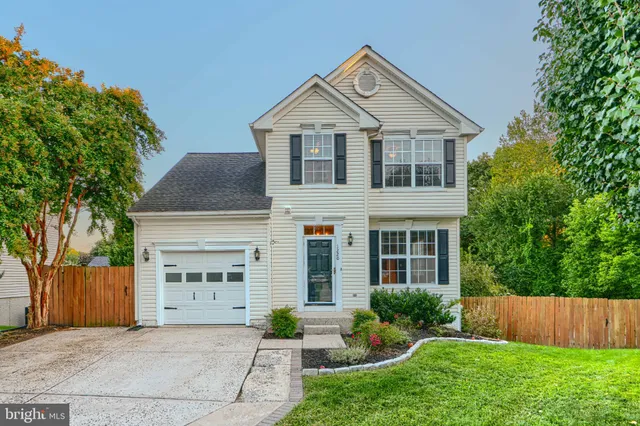front view of a house with yard and trees