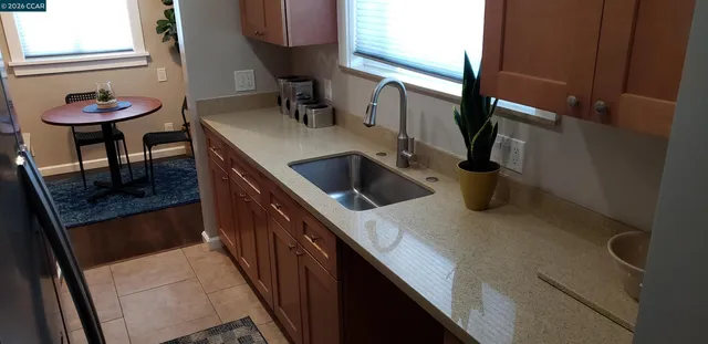 a kitchen with a sink and a refrigerator