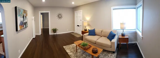 a living room with furniture and wooden floor