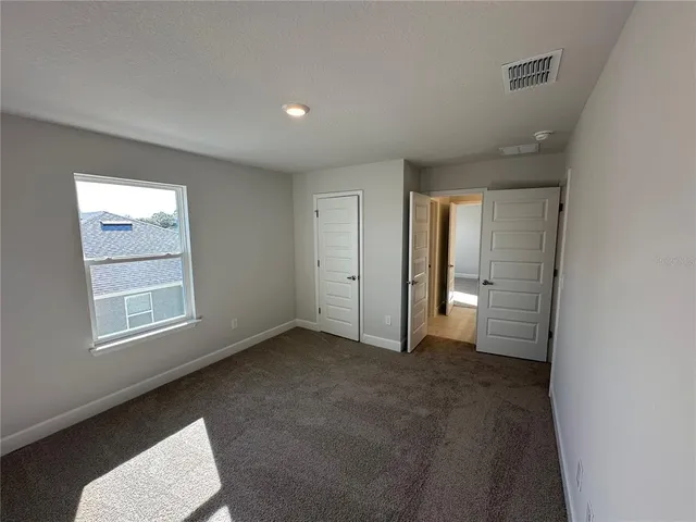 an empty room with closet area