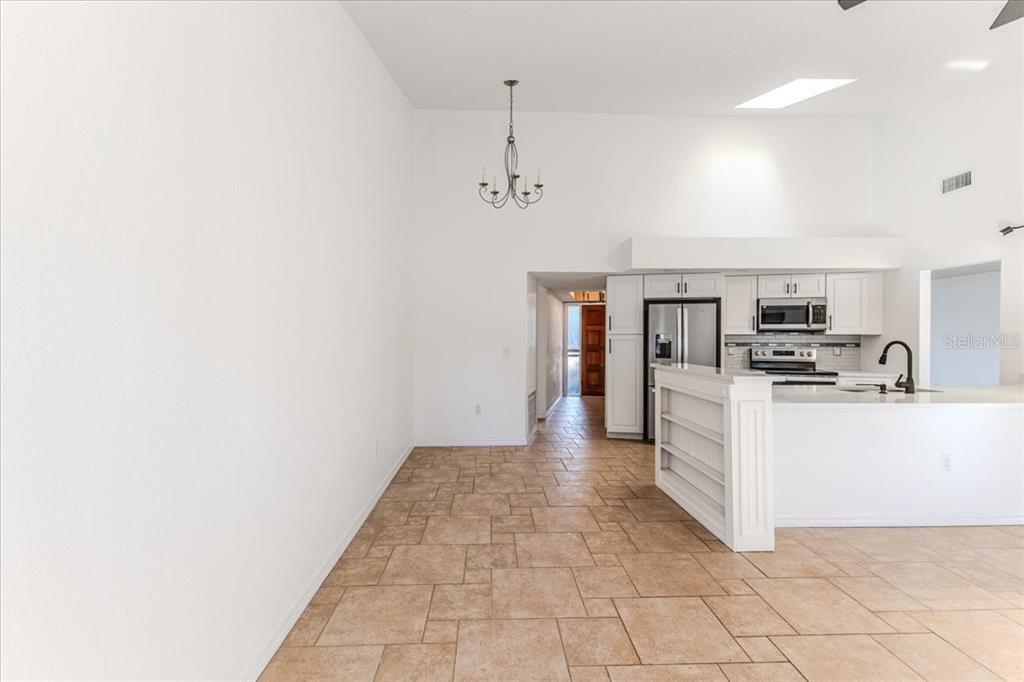 1382 Aladdin Road Spring Hill, FL 34609 - Photo 17 of 45 a large white kitchen with cabinets