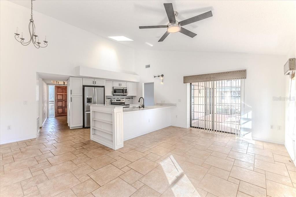 1382 Aladdin Road Spring Hill, FL 34609 - Photo 18 of 45 a large white kitchen with a large window cabinets and stainless steel appliances