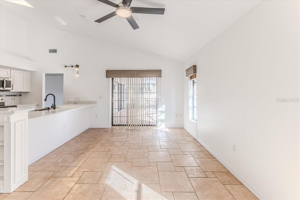 1382 Aladdin Road Spring Hill, FL 34609 - Photo 20 of 45 a large white kitchen with a sink a window and stainless steel appliances