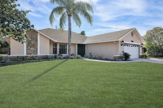 a front view of house with yard and trees