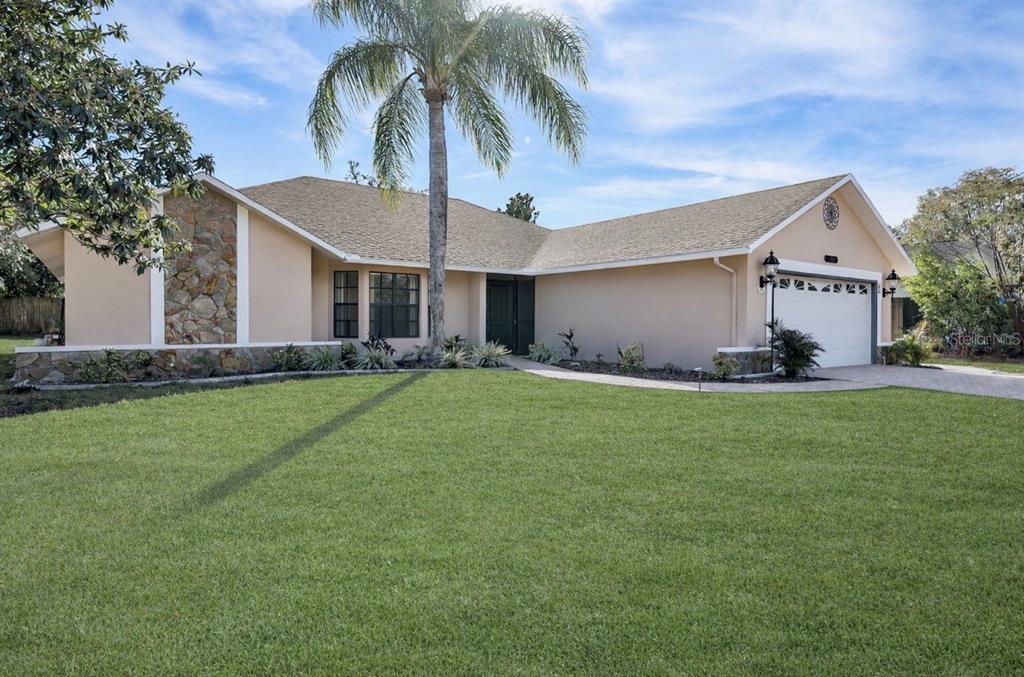 1382 Aladdin Road Spring Hill, FL 34609 - Photo 2 of 45 a front view of house with yard and trees