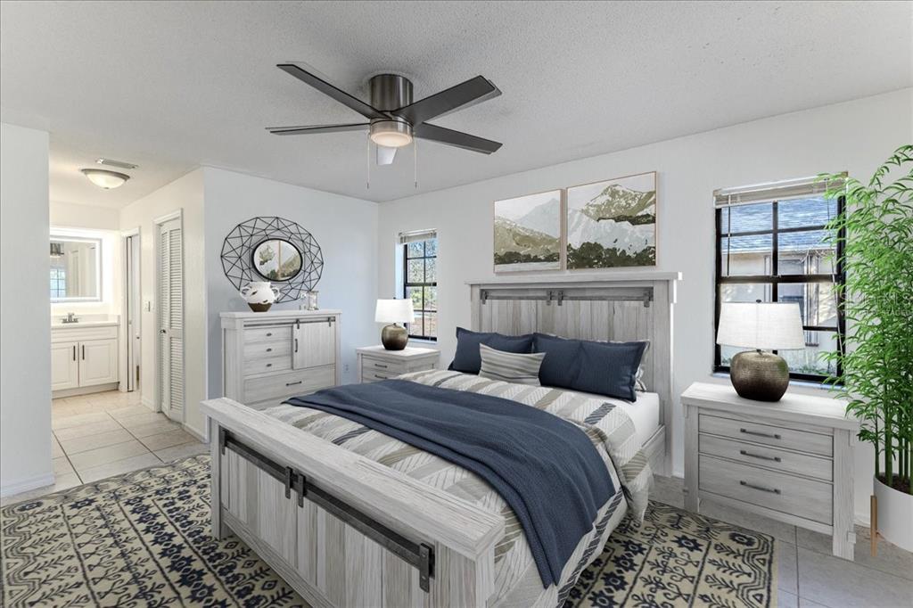 1382 Aladdin Road Spring Hill, FL 34609 - Photo 21 of 45 a bedroom with a large bed and a chandelier