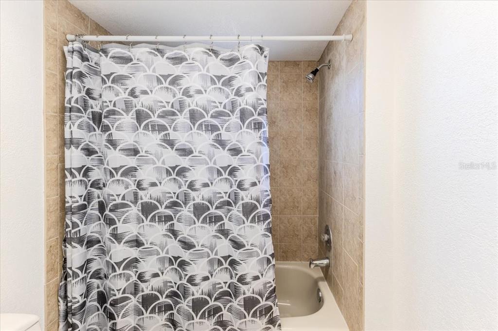 1382 Aladdin Road Spring Hill, FL 34609 - Photo 24 of 45 a bathroom with a shower curtain