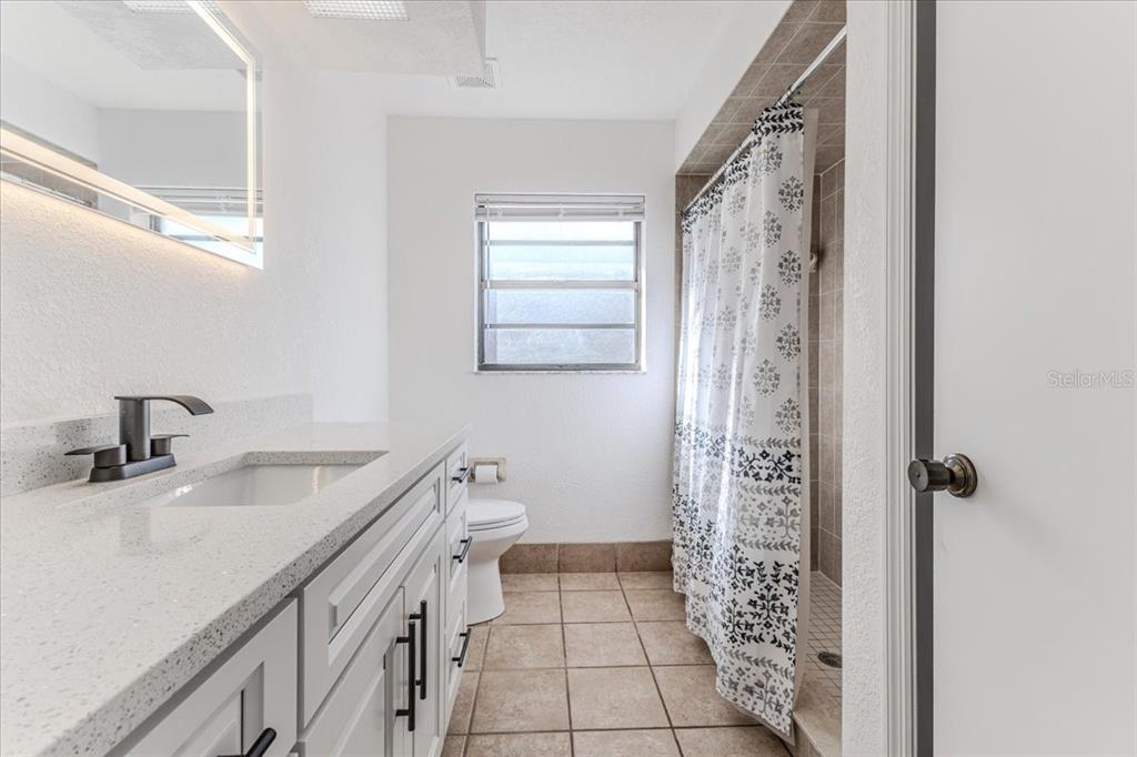 1382 Aladdin Road Spring Hill, FL 34609 - Photo 28 of 45 a bathroom with a sink a toilet and shower