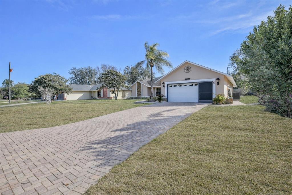 1382 Aladdin Road Spring Hill, FL 34609 - Photo 44 of 45 a front view of a house with a yard and garage