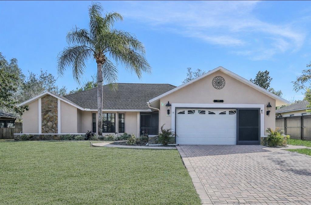 1382 Aladdin Road Spring Hill, FL 34609 - Photo 45 of 45 a front view of a house with a yard and garage