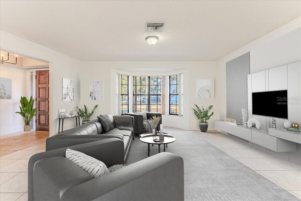 1382 Aladdin Road Spring Hill, FL 34609 - Photo 6 of 45 a living room with furniture and a flat screen tv