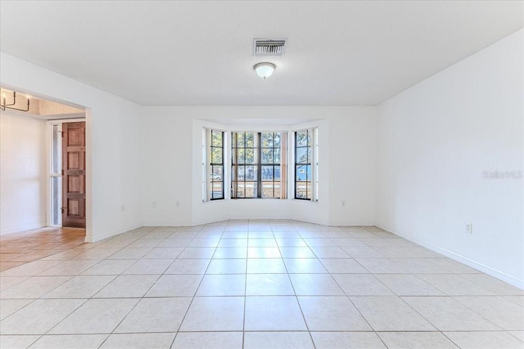 1382 Aladdin Road Spring Hill, FL 34609 - Photo 7 of 45 a view of an empty room with a window