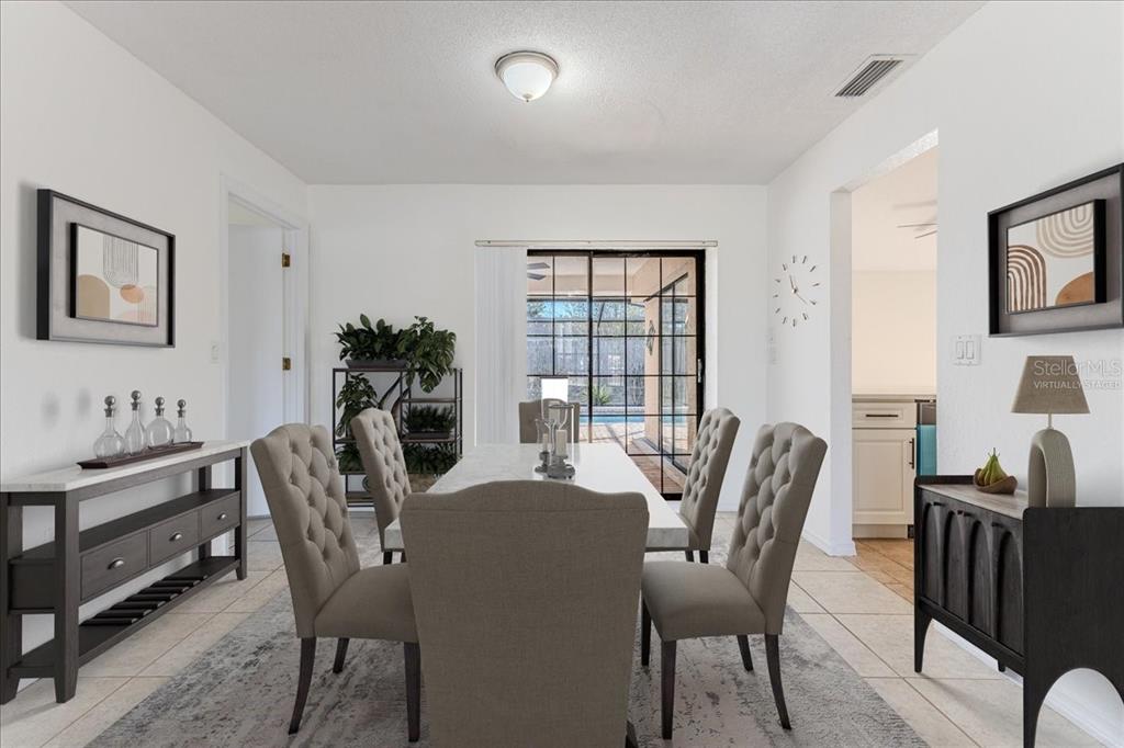 1382 Aladdin Road Spring Hill, FL 34609 - Photo 9 of 45 a dining room with furniture potted plants and wooden floor