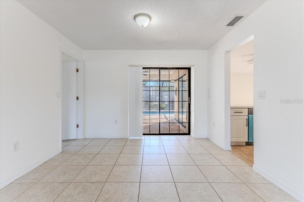 1382 Aladdin Road Spring Hill, FL 34609 - Photo 10 of 45 a view of an empty room with window and a bathroom