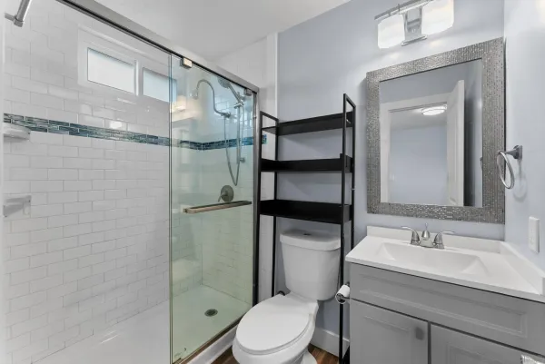 a bathroom with a sink toilet and shower