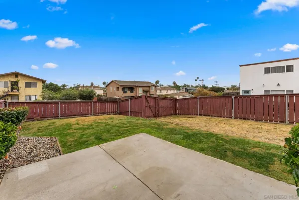 a view of a backyard with a garden and entertaining space