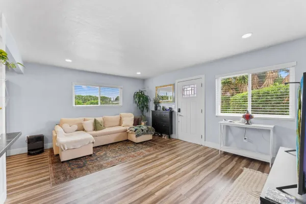 a living room with furniture window and wooden floor
