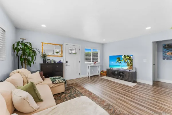 a living room with furniture and a flat screen tv