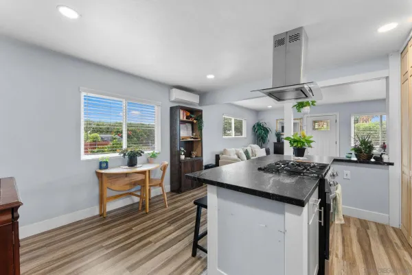 a kitchen with stainless steel appliances granite countertop sink stove and wooden floor