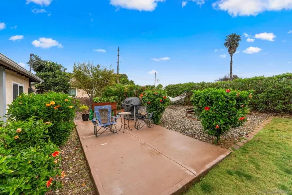 a view of a backyard with sitting area