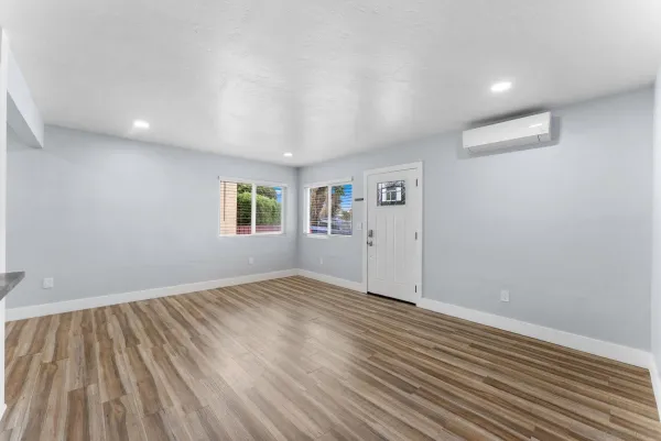 wooden floor in an empty room with a window