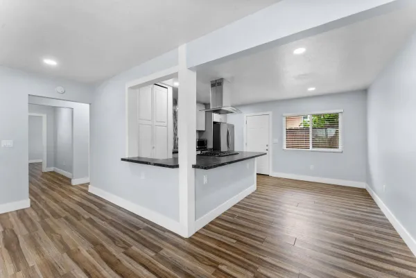 a view of kitchen with wooden floor and electronic appliances