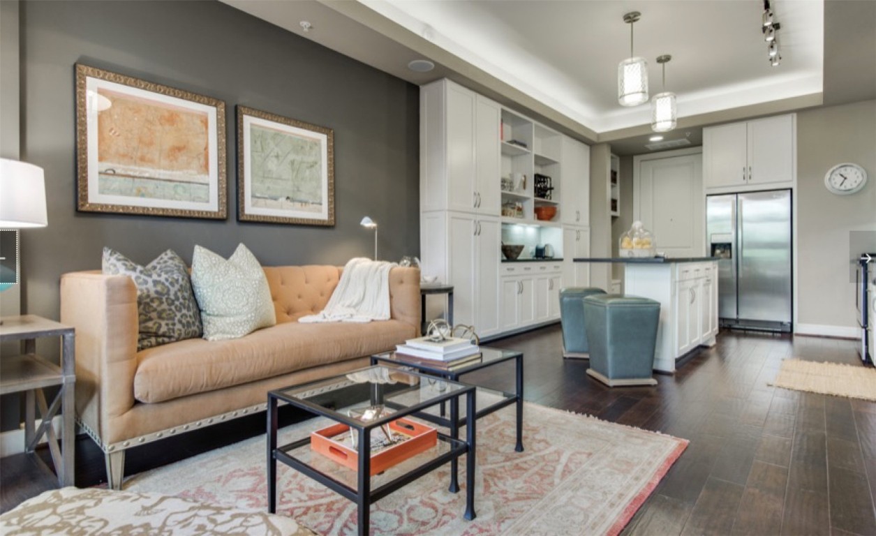 a living room with furniture and a chandelier