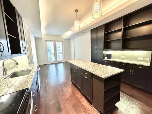 a bathroom with a granite countertop sink and a large mirror