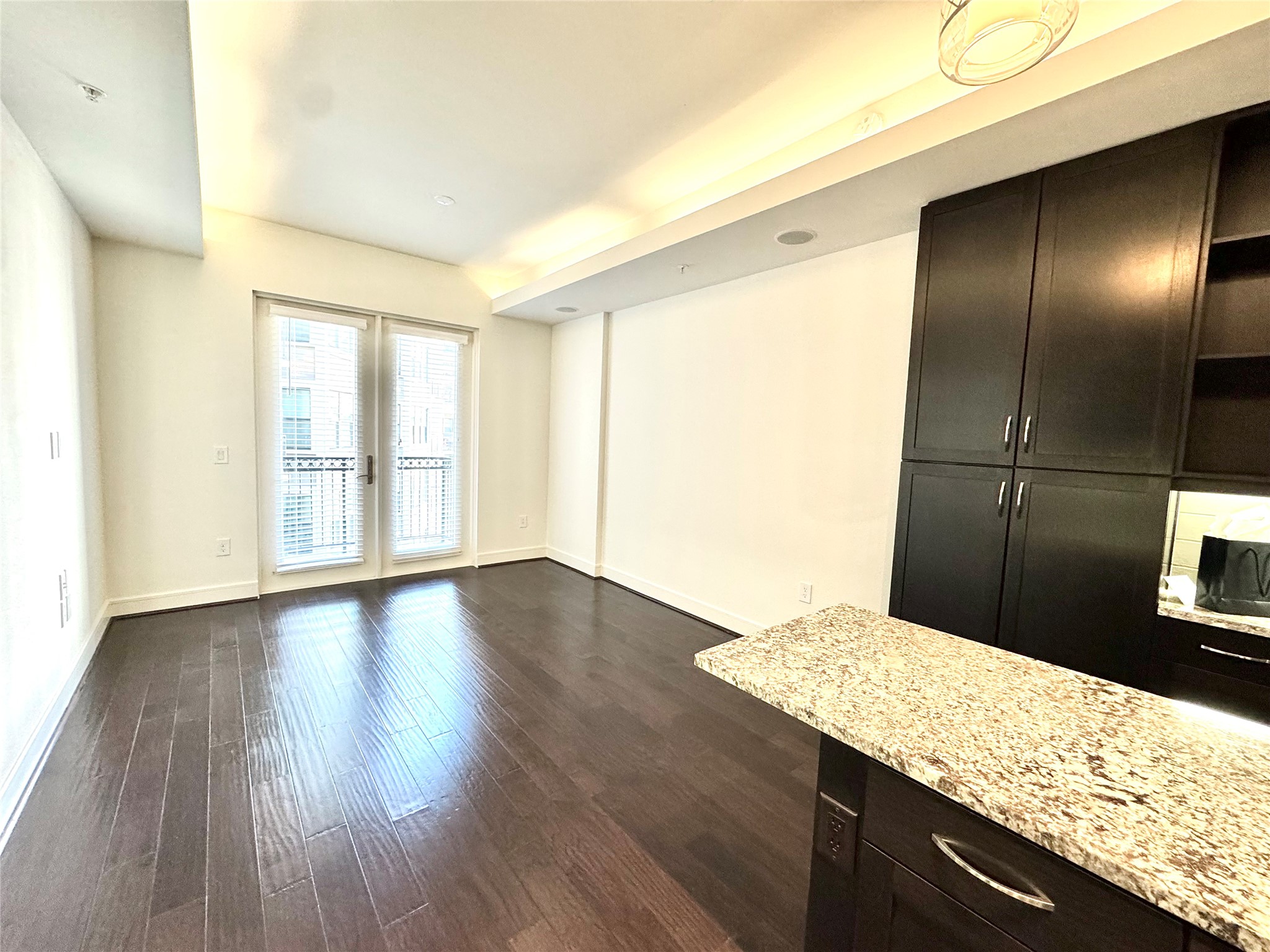 2303 Mid Lane, Unit 710 Houston, TX 77027 - Photo 13 of 19 a view of kitchen island wooden floor and window