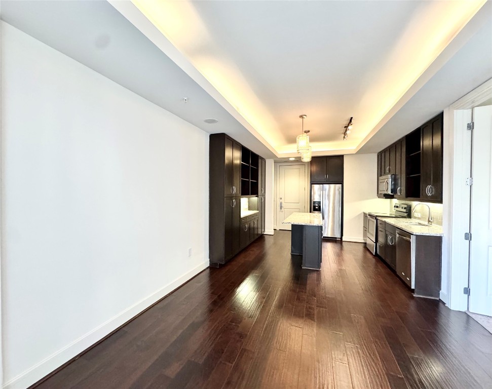 2303 Mid Lane, Unit 710 Houston, TX 77027 - Photo 19 of 19 a view of a large kitchen with furniture and wooden floor