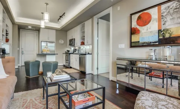a living room with furniture and wooden floor