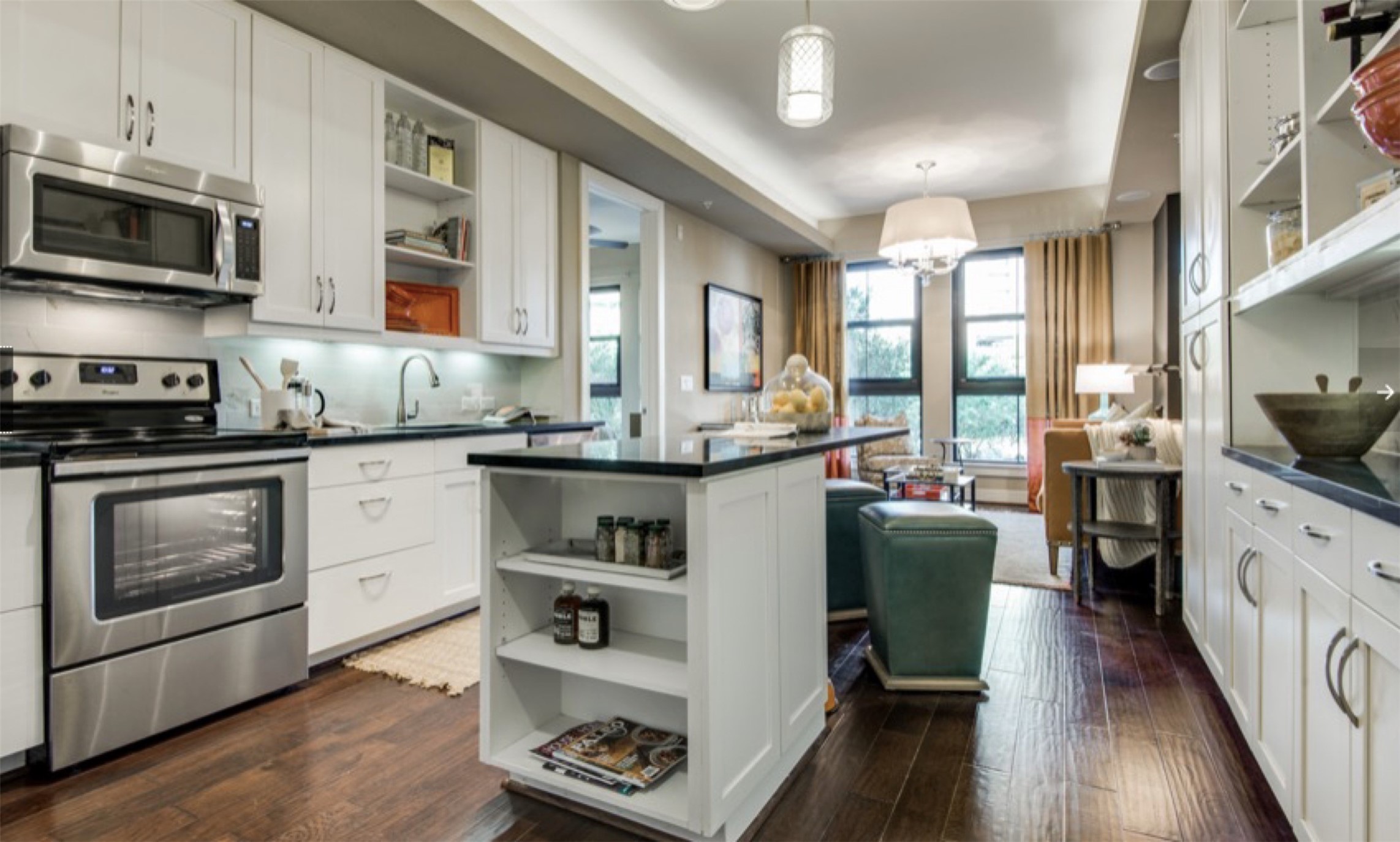 2303 Mid Lane, Unit 710 Houston, TX 77027 - Photo 3 of 19 a kitchen with stainless steel appliances granite countertop a stove top oven a sink dishwasher and a refrigerator with wooden floor