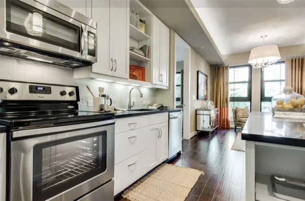 a kitchen with stainless steel appliances granite countertop a stove and a microwave