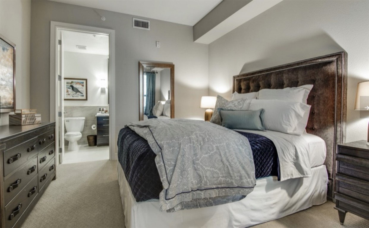 2303 Mid Lane, Unit 710 Houston, TX 77027 - Photo 6 of 19 a spacious bedroom with a bed and glass cabinets