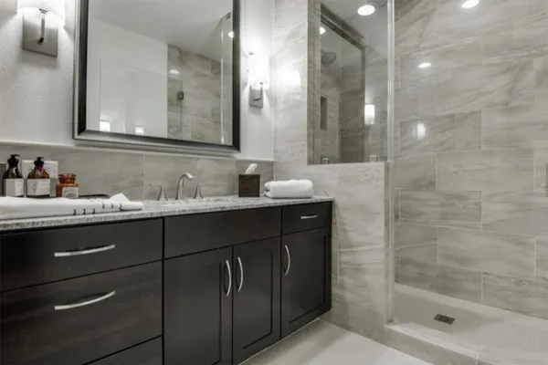 a bathroom with a granite countertop sink a toilet and a bathtub