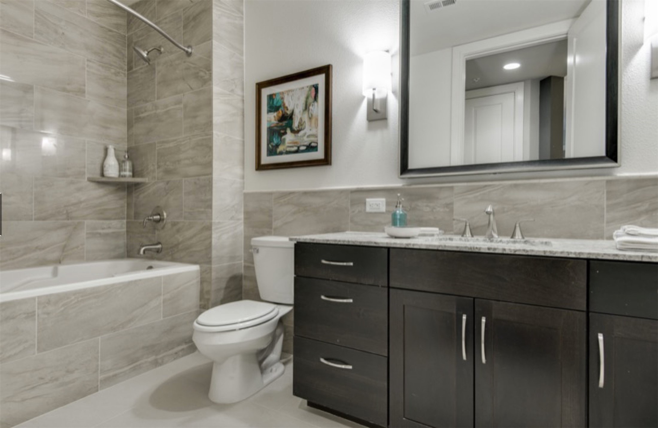 2303 Mid Lane, Unit 710 Houston, TX 77027 - Photo 9 of 19 a bathroom with a granite countertop sink a toilet and a bathtub