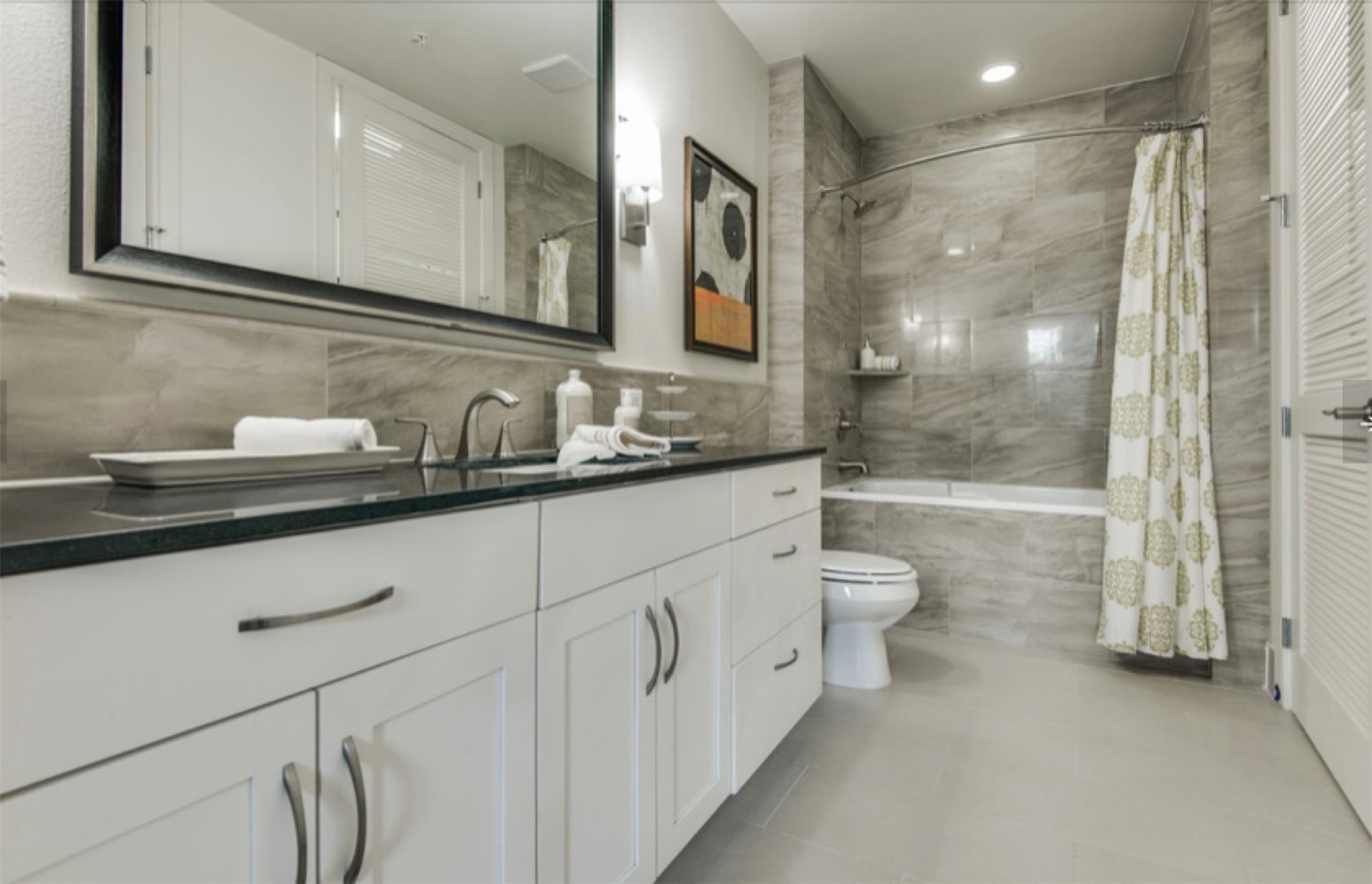 2303 Mid Lane, Unit 710 Houston, TX 77027 - Photo 10 of 19 a bathroom with a double vanity sink a toilet and shower