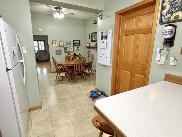 a very nice looking dining room with a dining table and a refrigerator