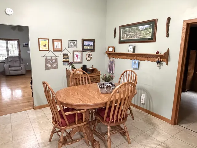a view of a dining room with furniture and a rug
