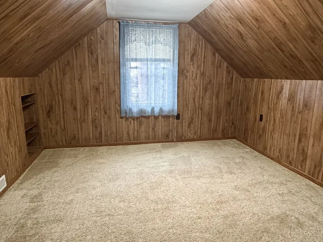 a view of an empty room with a kitchen