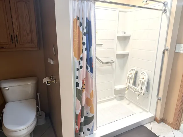 a bathroom with a toilet and a shower