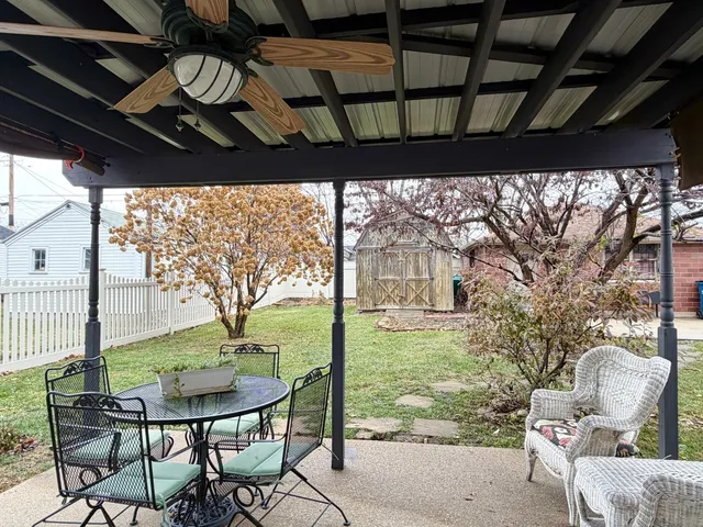 a view of a porch with furniture and a yard