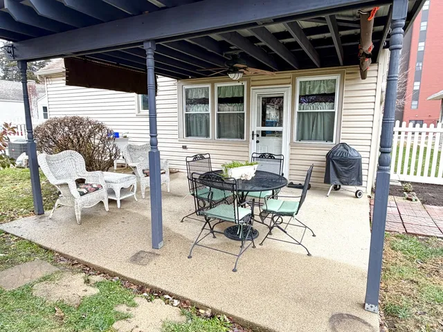 a building outdoor space with patio furniture and potted plants