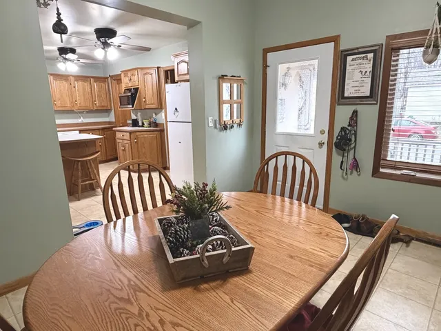 a dining room with wooden floor and chandelier