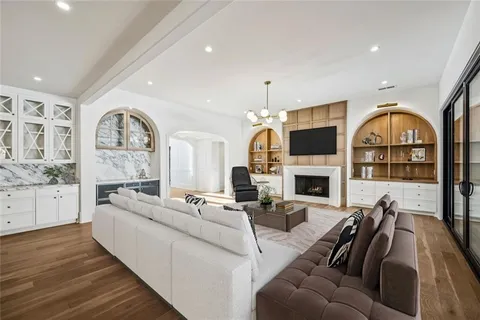 a living room with painting on the wall and a flat screen tv