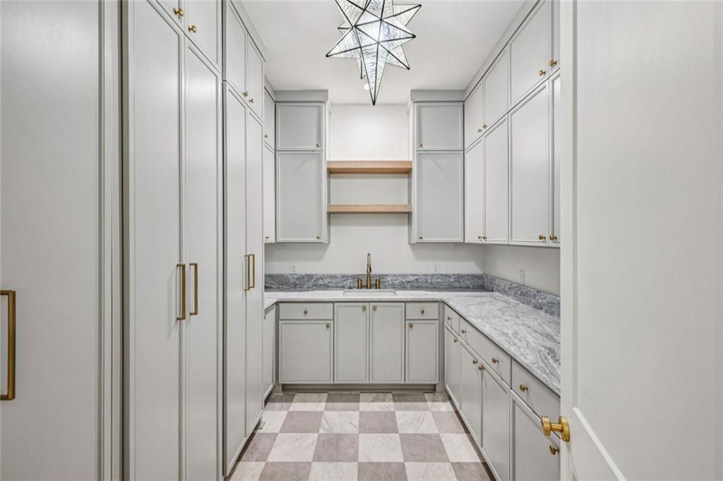 2854 North Thompson Road Northeast Brookhaven, GA 30319 - Photo 14 of 34 a kitchen with stainless steel appliances granite countertop a sink and dishwasher a refrigerator with white cabinets