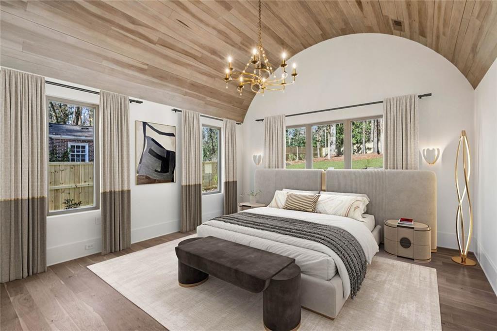 2854 North Thompson Road Northeast Brookhaven, GA 30319 - Photo 15 of 34 a bedroom with a large bed and a chandelier